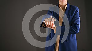 Closeup of business woman showing point finger forward. Isolated on gray background with copy space.