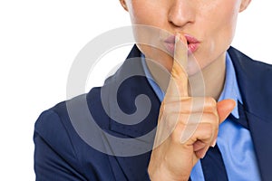 Closeup on business woman showing shh gesture