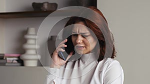 Closeup business woman talking friendly on cell phone at home or office. Portrait of pretty woman flirting on phone