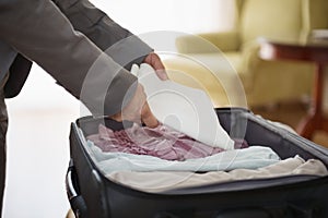 Closeup on business woman unpack luggage in hotel