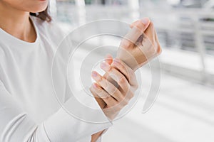 Closeup business women holding rub her wrist pain