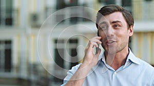 Closeup businessman celebrating victory. Man having phone talk at street