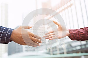 Closeup of a businessman hand shake businesswoman between two colleagues OK, succeed