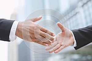 Closeup of a businessman hand shake investor between two colleagues  OK, succeed in business Holding hands.