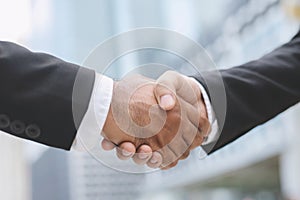 Closeup of a businessman hand shake investor between two colleagues  OK, succeed in business Holding hands.