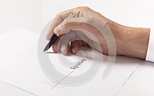 Closeup of businessman hand signing contract, signature close up