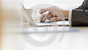 Closeup of businessman hands using laptop computer