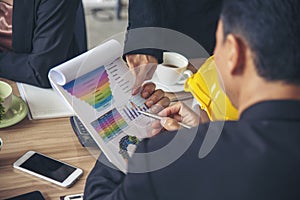 Closeup businessman hands working on finance business document reading report paperwork spreadsheet using laptop at office desk.