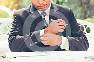 Closeup businessman hands working use laptop finance business document reading report paperwork spreadsheet at office desk. Man