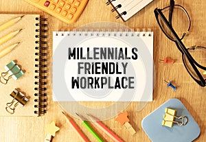 Closeup on businessman holding a card with text MILLENNIALS FRIENDLY WORKPLACE , business concept image