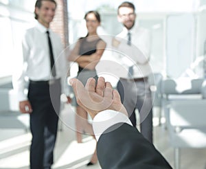 Closeup. businessman holding out hand for a handshake.