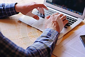 Closeup of businessman is keyboarding on portable net-book