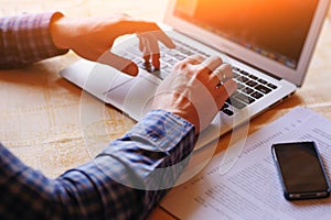 Closeup of businessman is keyboarding on portable net-book