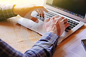 Closeup of businessman is keyboarding on portable net-book