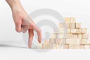 Closeup of businessman making a pyramid with empty wooden cubes