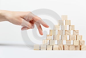 Closeup of businessman making a pyramid with empty wooden cubes