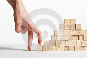 Closeup of businessman making a pyramid with empty wooden cubes