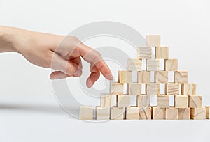 Closeup of businessman making a pyramid with empty wooden cubes