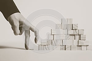 Closeup of businessman making a pyramid with empty wooden cubes