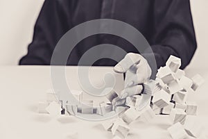 Closeup of businessman making a pyramid with empty wooden cubes