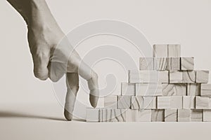 Closeup of businessman making a pyramid with empty wooden cubes