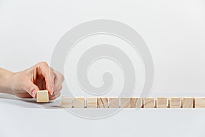 Closeup of businessman making a pyramid with empty wooden cubes