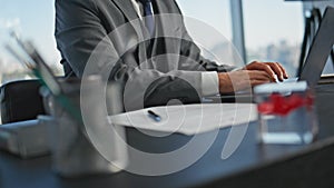 Closeup businessman open laptop in office. Worker hands typing computer online