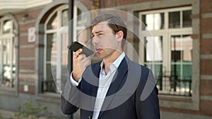 Closeup businessman talking phone outdoor. Businessman having phone conversation