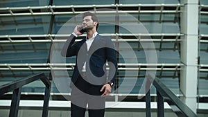 Closeup businessman talking phone outside. Businessman checking time on watch