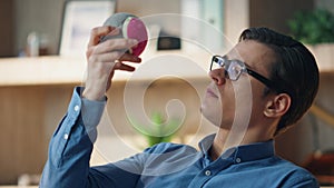 Closeup businessman tossing ball at office. Relaxed freelancer taking work break