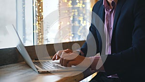 Closeup of businessman typing on laptop computer