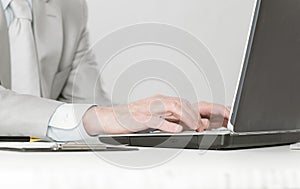 Closeup of businessman typing on laptop computer