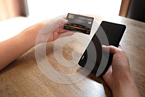 Closeup businessman using blank screen mobile phone and credit card for online payment. image for internet, commerce, technology,