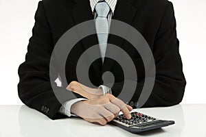 Closeup of a businessman using a calculator