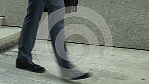 Closeup of businessman walking downstairs, concept of setbacks in career