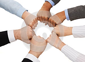 Closeup of businesspeople hands in fists in circle