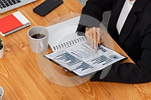 Closeup businesswoman analyzing financial paper at harmony office workplace.