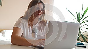 Closeup businesswoman hands typing laptop keyboard in open space. Serious manager messaging with client at workplace
