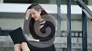 Closeup businesswoman working with laptop. Female sitting on stairs outside