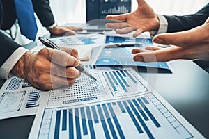 Closeup busy analyst team discussing financial data on laptop. Fervent