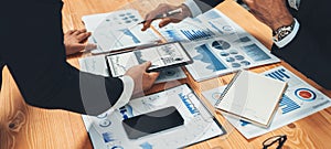 Closeup busy analyst team discussing financial data on laptop. Fervent