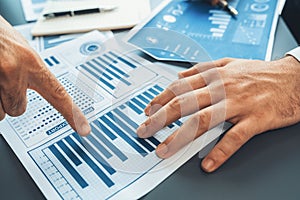 Closeup busy analyst team discussing financial data on laptop. Fervent