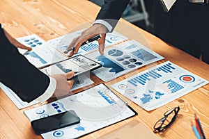 Closeup busy analyst team discussing financial data on laptop. Fervent