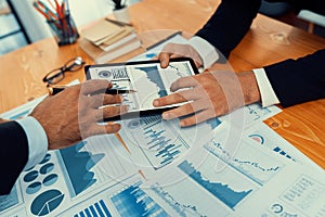 Closeup busy analyst team discussing financial data on laptop. Fervent