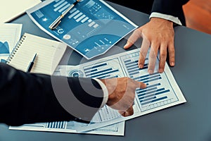 Closeup busy analyst team discussing financial data on laptop. Fervent