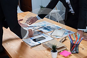 Closeup busy analyst team discussing financial data on laptop. Fervent