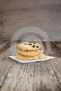 Closeup Butter cookies with chocolate chip topping on wooden ba