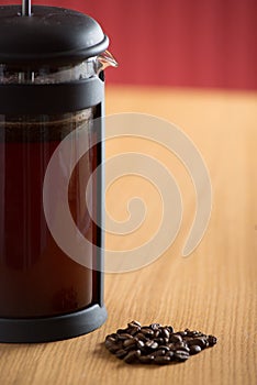 Closeup of cafetiere with coffee beans in front photo