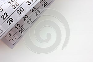 Closeup of calendar page on white office desk background. Planing work, agenda or date concept.