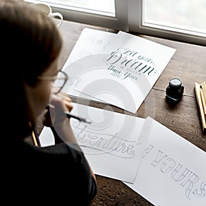 Closeup of a calligrapher working on a project photo